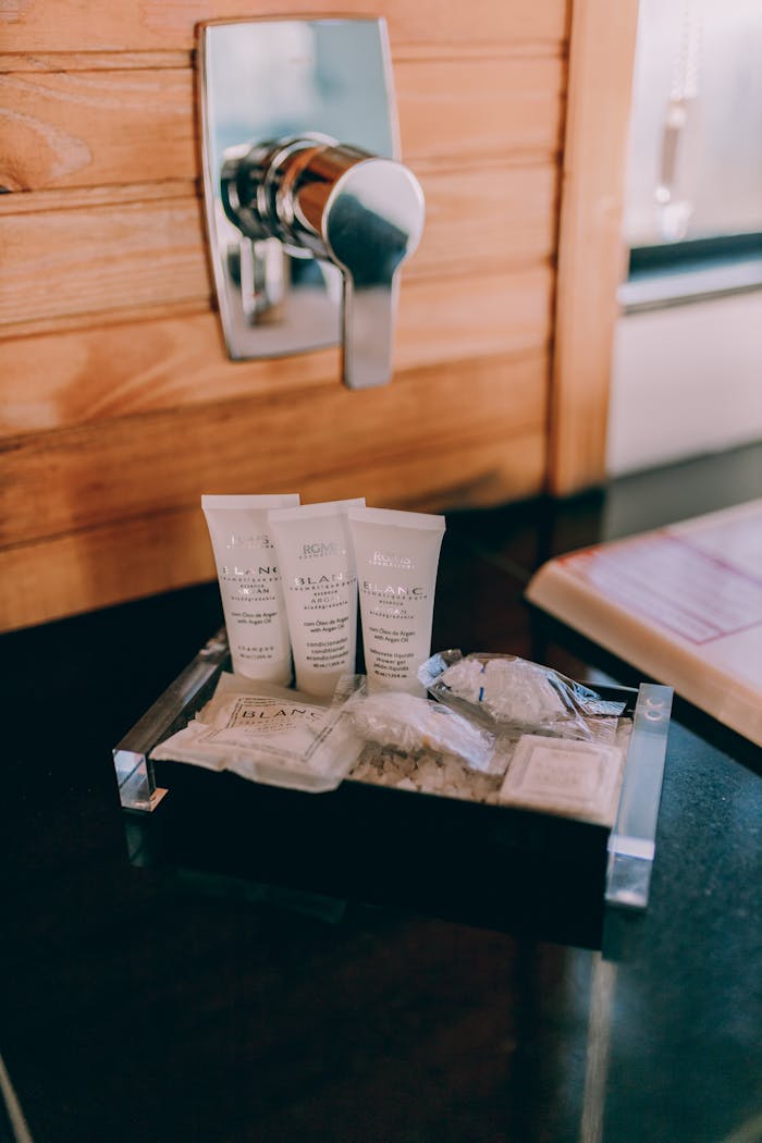 A bathroom with a sink, toilet and soap